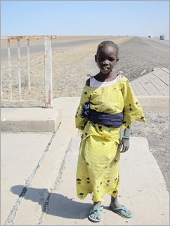 3b. Girl collecting dung at canal